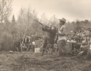 Scout Leader Teaches Scout How to Shoot