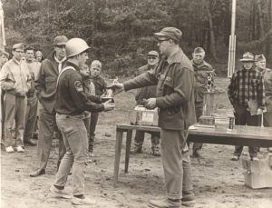 Scout Receives Trophy From Leader
