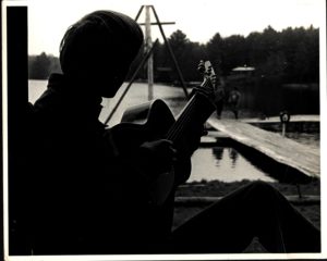Scout Plays Guitar Near Camp Russell Dock