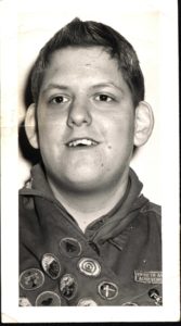 Smiling Scout in Merit Badge Sash