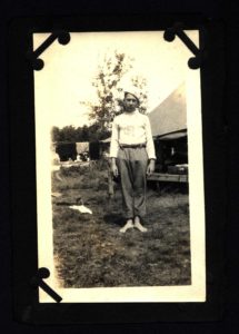 Scout Stands at Attention Outside Tent