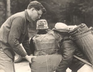 Scout Leader Helps Scouts Load Bags